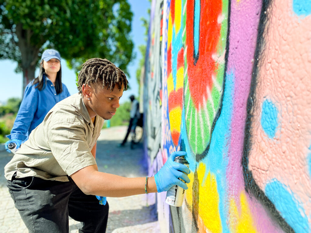 Participant in a creative flow state during a professional graffiti workshop for groups in Berlin.