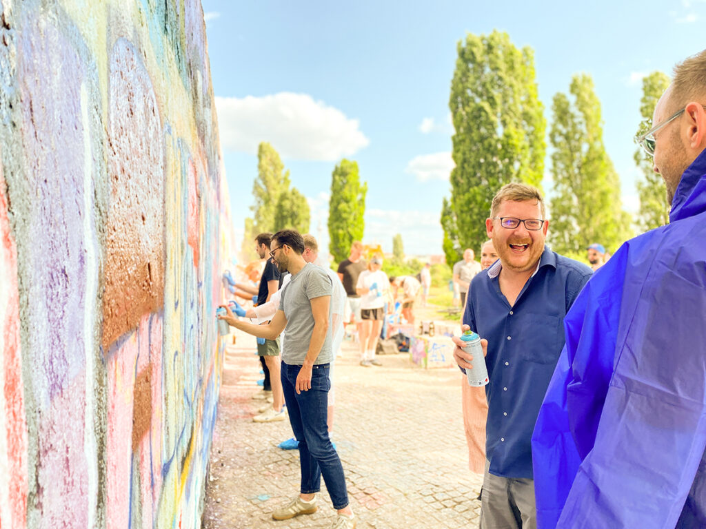 Professional high-quality event photography showing participants in creative flow during a Berlin graffiti workshop.